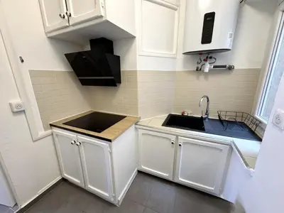 a small kitchen with white cabinets and a sink at C OT Maison de la Place - Old Town in Nice