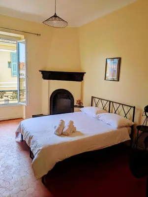 a bedroom with a bed with two towels on it at Heart of city 62m2 in Nice