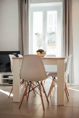 a white dining room table with two chairs and a table at Le Trendy, plein centre avec climatisation in Nice