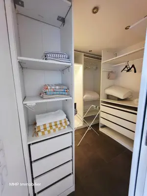 a walk in closet with white drawers and shelves at La Palombière in Cagnes-sur-Mer
