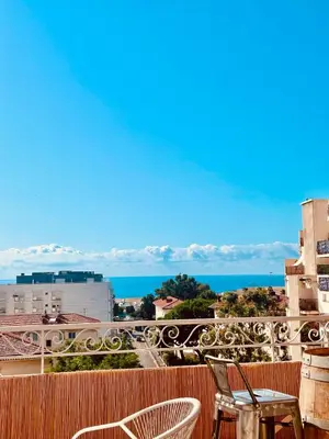 a balcony with chairs and a view of the ocean at Votre grand COCON Niçois Appart Vue Mer in Nice