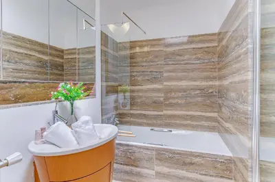 a bathroom with a tub and a sink at PANORAMIC ESTEREL AP4475 By Riviera Holiday Homes in Villefranche-sur-Mer