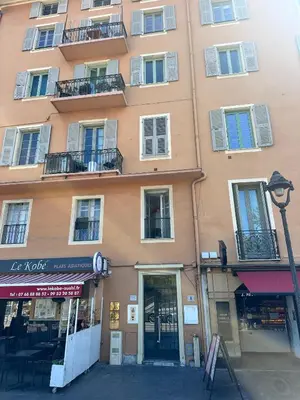 a large building on a city street with a store at Two suites with AC in the heart of Old Nice, each with its own entrance in Nice