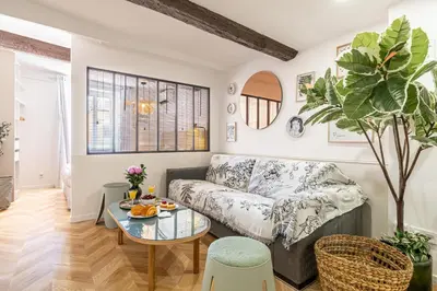 a living room with a couch and a table at Two suites with AC in the heart of Old Nice, each with its own entrance in Nice