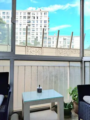 a table on a balcony with a view of a building at T1 Bord De Mer Nice West in Nice