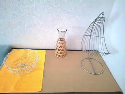 a table with a lamp and a vase on it at T1 Bord De Mer Nice West in Nice