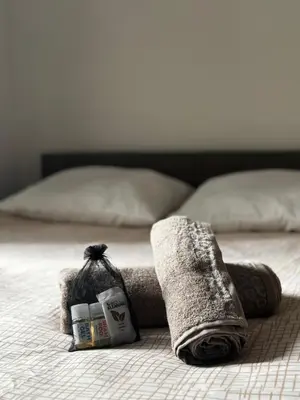 a bed with two towels and some medicines on it at Appartement confort au cœur de Nice in Nice