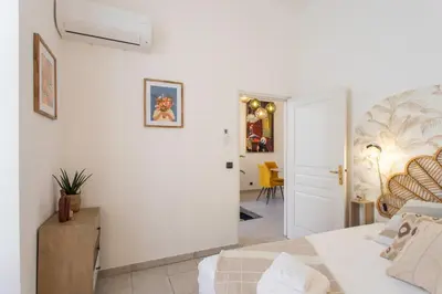 a white bedroom with a bed and a living room at #56 2P Massena Central close promenade,Old Town, AC in Nice