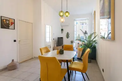 a dining room with a table and yellow chairs at #56 2P Massena Central close promenade,Old Town, AC in Nice