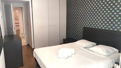 a bedroom with a bed with two towels on it at Superbe appartement carre d or in Nice