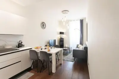 a kitchen and dining room with a white table and chairs at #60 Grimaldi 2BDR central near beach,promenade AC&WIFI in Nice