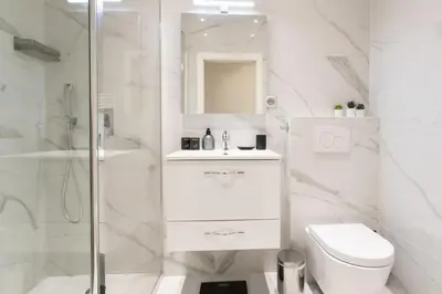 a white bathroom with a toilet and a shower at #60 Grimaldi 2BDR central near beach,promenade AC&WIFI in Nice