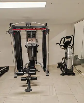 a gym with exercise equipment and a scooter at Contemporary Villa with Sea View, Infinity Swimming pool, Gym , Cinema room,Lift in Nice