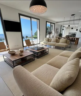 a living room with a couch and a table at Contemporary Villa with Sea View, Infinity Swimming pool, Gym , Cinema room,Lift in Nice