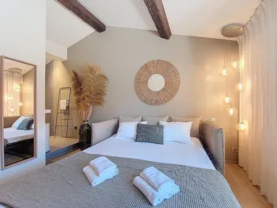 a bedroom with a large bed with two pillows on it at Nestor&Jeeves - BEIGE RIVIERA - Standing suite in Nice