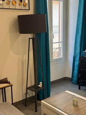 a lamp in a room with blue curtains at Agreable 2 pièces Nice liberation in Nice