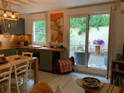 a kitchen with a table and a dining room at L'Échappée Belle in Nice