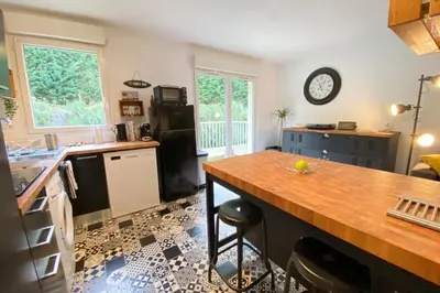 a kitchen with a wooden counter top in a room at Beautiful apartment on the heights of Nice - Parking in Nice