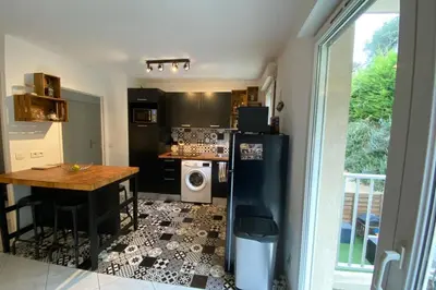 a kitchen with a black refrigerator and a table at Beautiful apartment on the heights of Nice - Parking in Nice