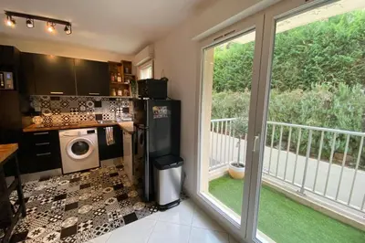 a kitchen with a refrigerator and a sliding glass door at Beautiful apartment on the heights of Nice - Parking in Nice