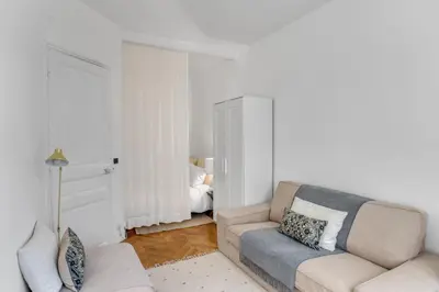 a living room with a couch and a bed at Nice design, calme & gare à 5 min à pied in Nice
