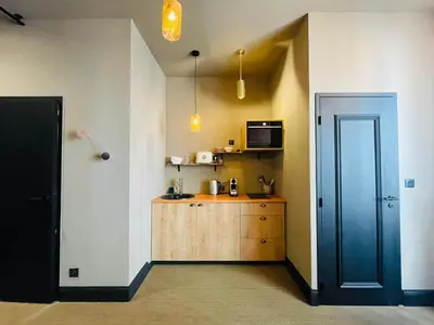 a kitchen with a blue door and a wooden cabinet at L'Embarcadère - Port de Nice in Nice