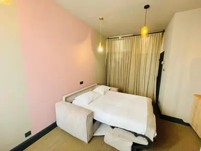 a small bedroom with a bed and a couch at L'Embarcadère - Port de Nice in Nice