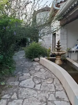 a garden with a stone walkway and a fountain at Magnifique Villa sur les collines de Nice, 6 Pièces, clim, barbecue, sauna et hammam in Nice