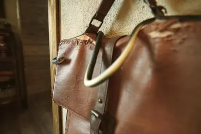 a brown purse is hanging on a wall at Suite des aventuriers - Expérience Unique & Atypique à Nice proche du centre in Nice