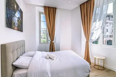 a bedroom with a bed with a towel on it at Magnifique appartement - Jacuzzi - Port de Nice in Nice