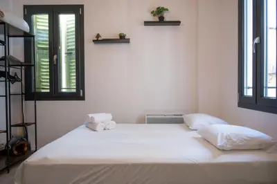 a white bed in a room with two pillows on it at Gambetta stay near attractions in Nice
