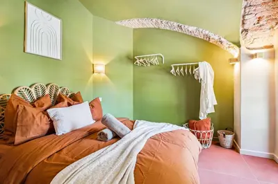a bedroom with a bed in a room with green walls at Nice Renting - CROTTI - Authentic Immersion Sea & Beach Massena in Nice