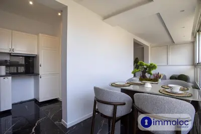 a kitchen and dining room with a table and chairs at Air-conditioned apartment in the Carras district close to the sea in Nice