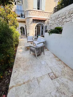 a patio with two benches and a table at Appartement 1 chambre - grande terrasse in Nice