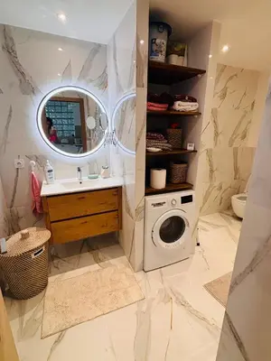 a bathroom with a sink and a washing machine at Appartement 1 chambre - grande terrasse in Nice