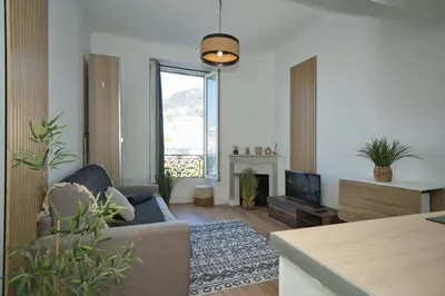 a living room with a couch and a fireplace at Nissa la bella in Nice