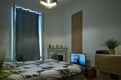a bedroom with a bed and a tv and a window at Nissa la bella in Nice
