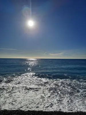 a full moon rising over the ocean on a beach at Appartement 3 chambres spacieux prés des plages à Nice in Nice