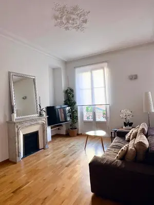 a living room with a couch and a fireplace at L'appart in Nice