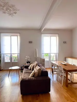 a living room with a couch and a table at L'appart in Nice