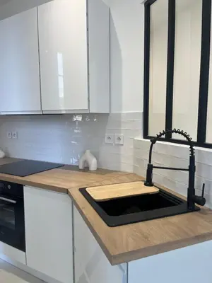 a kitchen with white cabinets and a counter top at Havre de Paix à Nice in Nice