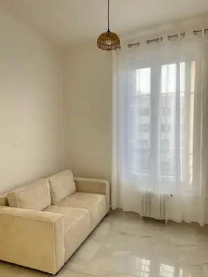 a living room with a couch and a window at Havre de Paix à Nice in Nice