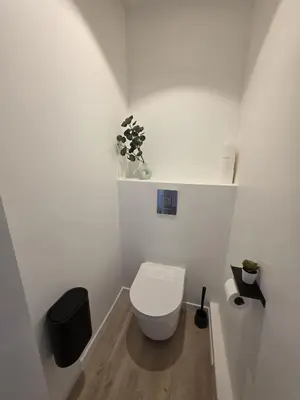 a white bathroom with a toilet in a room at Magnifique appartement Carré Or in Nice