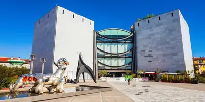 a statue of a goat in front of a building at Rossetti in Nice
