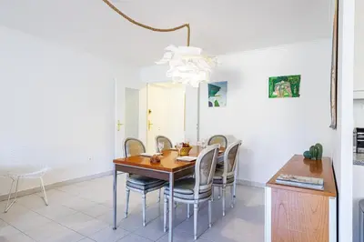 a dining room with a table and chairs at FEEL HOME - CAIS De PIERLAS in Nice