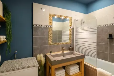 a bathroom with a sink and a mirror at Vieux Nice Design & confort Mer à 2 min in Nice