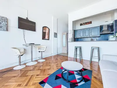 a living room with a couch and a table at Studio Le Savoy Promenade des Anglais-5 by Interhome in Nice