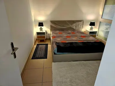 a small bedroom with a bed and two night stands at Résidence le vernier in Nice