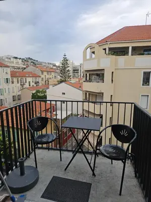 a table and chairs on a balcony with a view at Résidence le vernier in Nice
