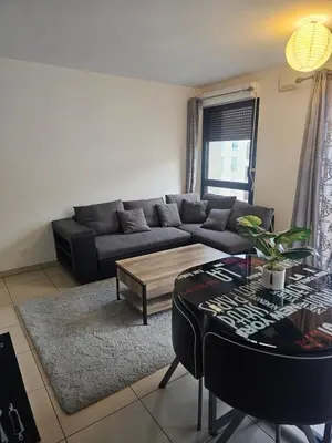 a living room with a couch and a table at Résidence le vernier in Nice